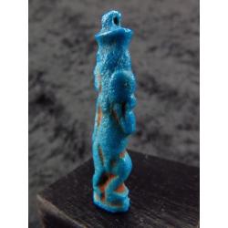 Egyptian faience amulet of Bes, dancing and playing the tamb